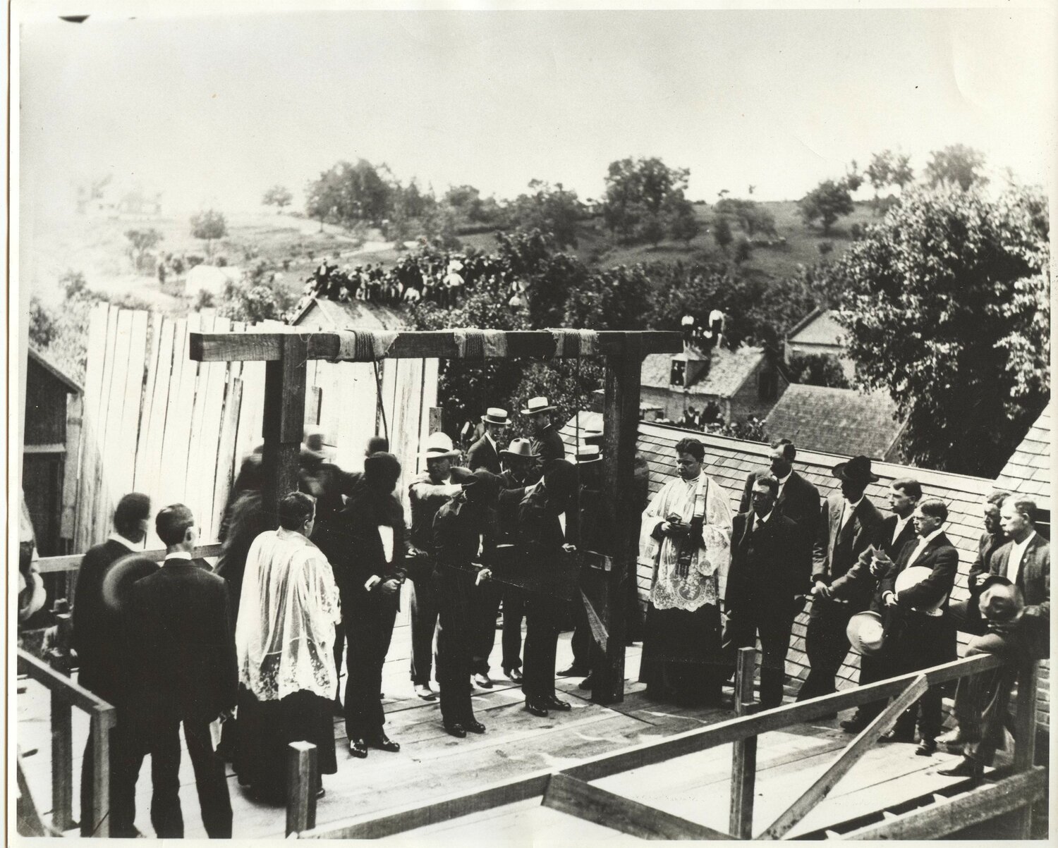 Father Henry Geisert, Catholic chaplain at the Missouri State Penitentiary and associate pastor of St. Peter Parish in Jefferson City, and Father Joseph Selinger, pastor, accompany three men who were condemned to die by hanging in their last moments on June 27, 1907.